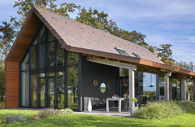 Modern barn house with unique louvers featured in The Art of Living Magazine